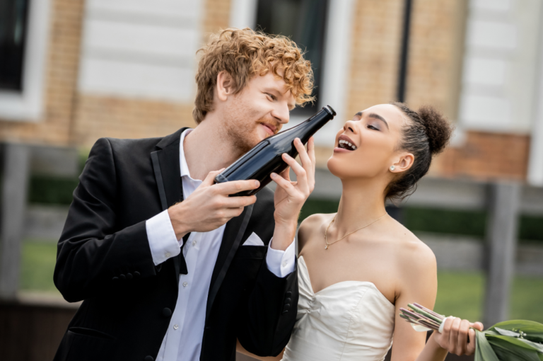 redhead-groom-holding-champagne-bottle-near-africa-2023-11-27-05-04-24-utc